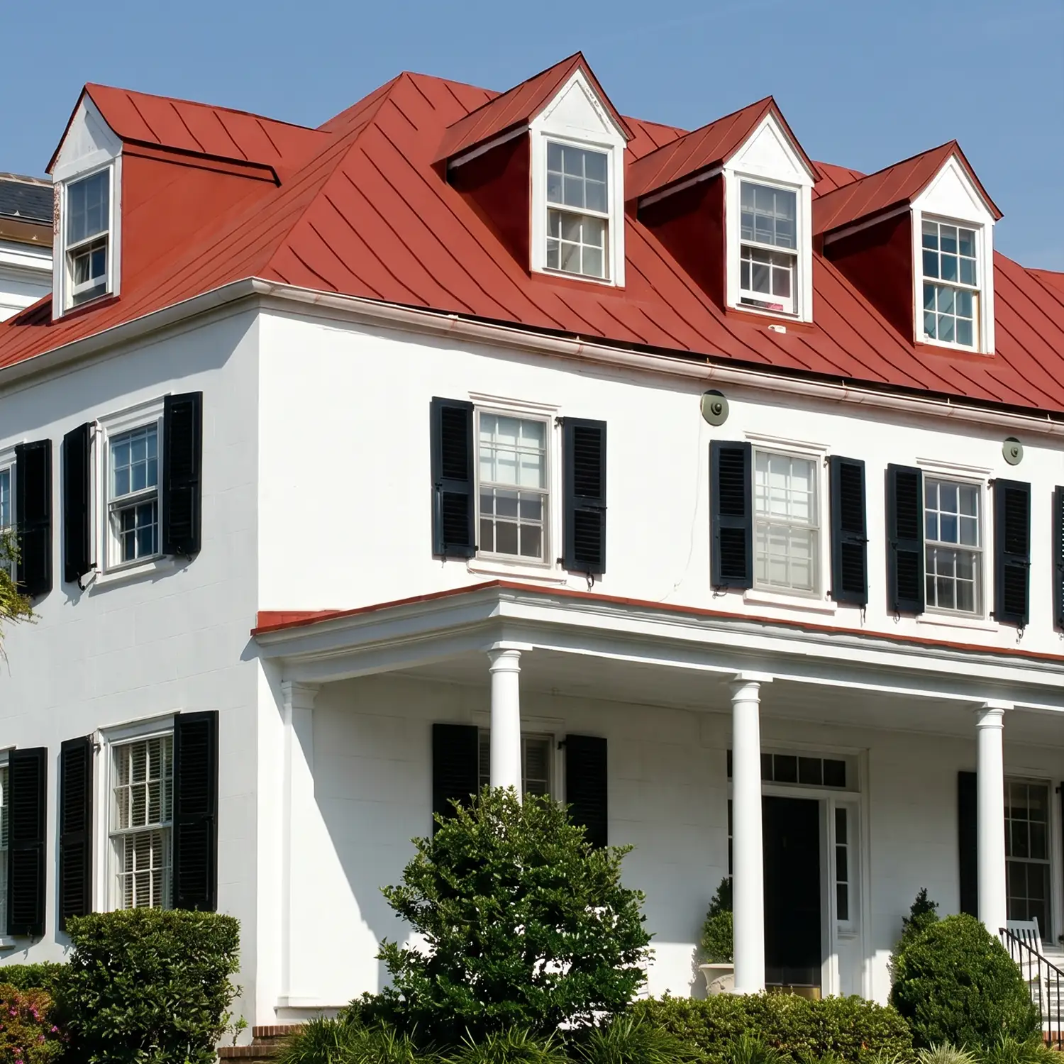 red metal roof on a white house - Infinity Roofing - A Stronghouse Partner blue house with new siding